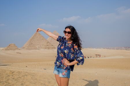 woman on background of egyptian pyramidsの写真素材