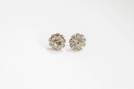 round silver earrings with diamonds on a whiteの写真素材