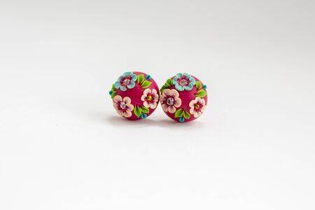 painted red earrings on white backgroundの写真素材