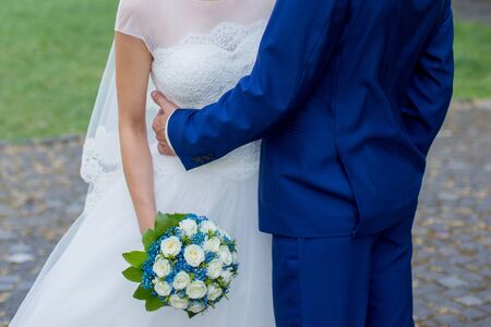 bride and groom together in parkの写真素材