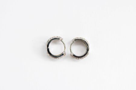 round silver earrings on a white backgroundの写真素材