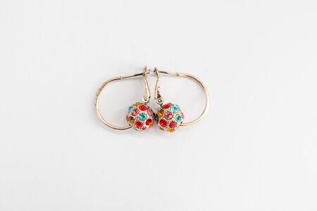 a gold earrings with colorful stonesの写真素材