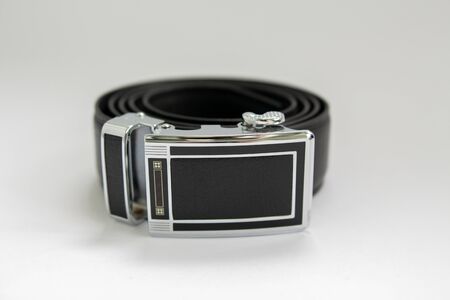 black leather belt on a white backgroundの写真素材