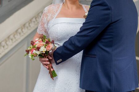 groom with bride and a bouquet of flowers