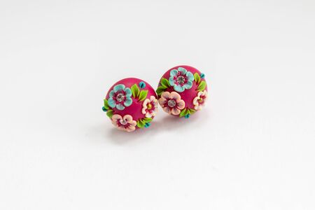 painted red earrings on white backgroundの写真素材