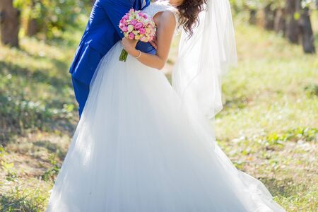 bride and groom in park among the treesの写真素材