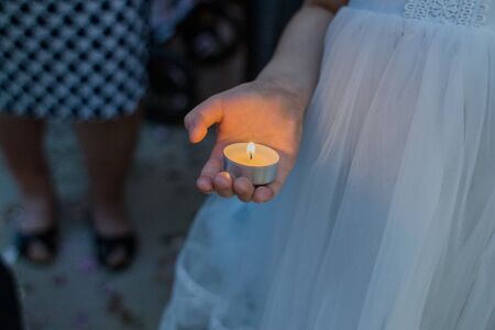 candle in the hand of childの写真素材