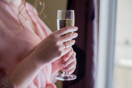 woman in peignoir with glass of champagneの写真素材