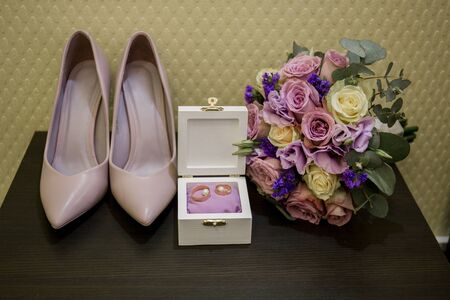 wedding rings with shoes and bouquetの写真素材