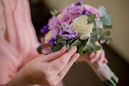 woman in peignoir with wedding bouquetの写真素材