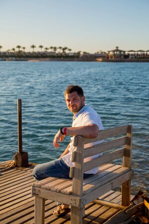 a man in shirt near the seaの写真素材