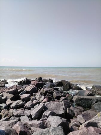 stones by the sea on cloudy dayの写真素材