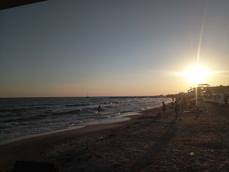 sunset on sea with muddy waterの写真素材