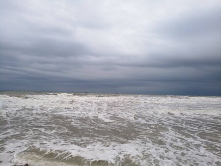 muddy sea water on cloudy dayの写真素材