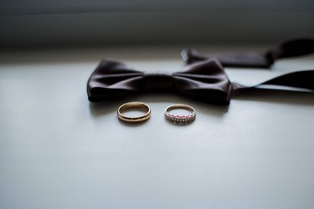 a bow tie with wedding ringsの写真素材