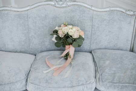 bridal wedding bouquet on bedの写真素材