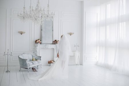 a bride in peignoir with wedding dressの写真素材