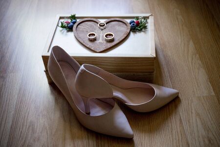 a wedding gold rings with bride shoes and decor
