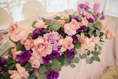 banquet table in a restaurant with flower decorの写真素材