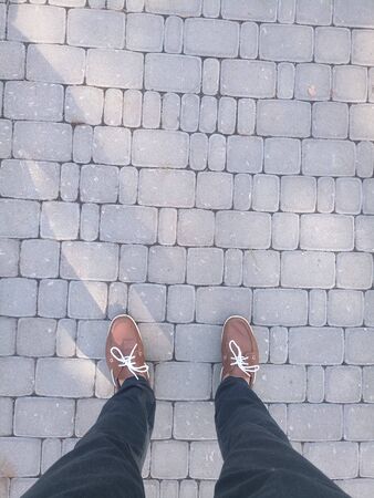 legs of man in brown shoesの写真素材