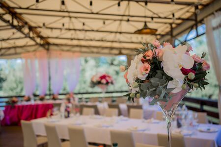 banquet table in a restaurant with flower decorの写真素材