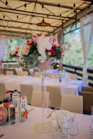 banquet table in a restaurant with flower decorの写真素材