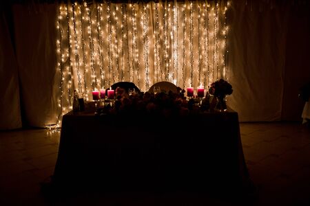 candles burn on a table in restaurantの写真素材