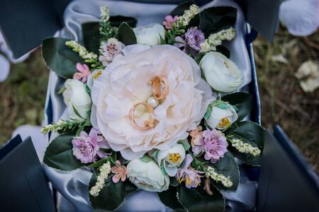 wedding gold rings in box with flowersの写真素材