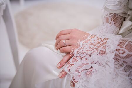 bride in peignoir in the morning at weddingの写真素材