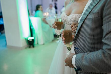 a bride and groom hold wedding glassesの写真素材