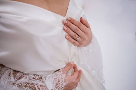 bride in peignoir in the morning at weddingの写真素材
