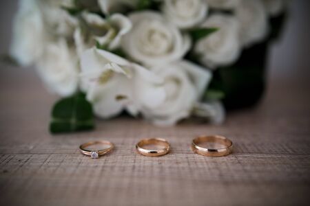 wedding gold rings near bouquetの写真素材