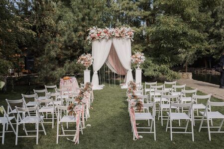 arch for wedding ceremony with flowers in parkの写真素材