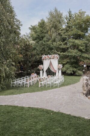 arch for wedding ceremony with flowers in parkの写真素材