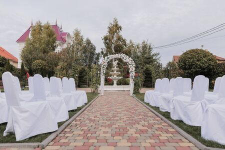 arch for wedding ceremony with flowers in parkの写真素材