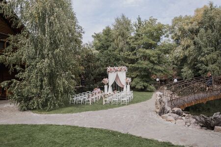 arch for wedding ceremony with flowers in parkの写真素材