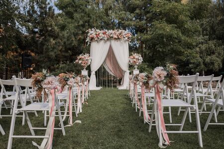 arch for wedding ceremony with flowers in parkの写真素材
