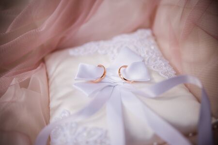 wedding gold rings on small pillowの写真素材