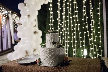 large white wedding cake in eveningの写真素材