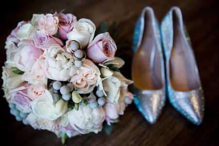 wedding gold rings on bride's bouquetの写真素材