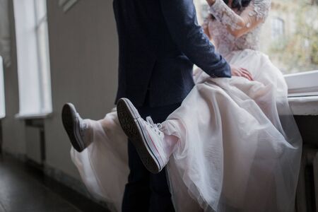 bride wearing wedding dress and sneakersの写真素材