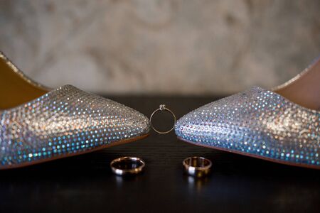 a bride wedding shoes with gold ringsの写真素材