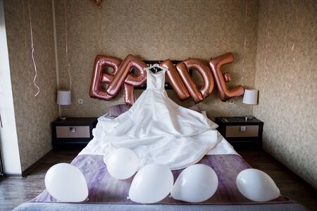 wedding dress on the bed in morningの写真素材