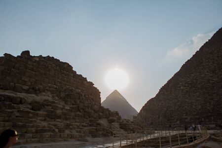 sunset on the background of Egyptian pyramidsの写真素材