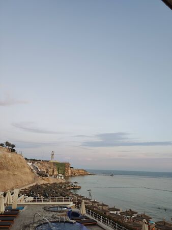 beach near the sea with umbrellas in eveningの写真素材
