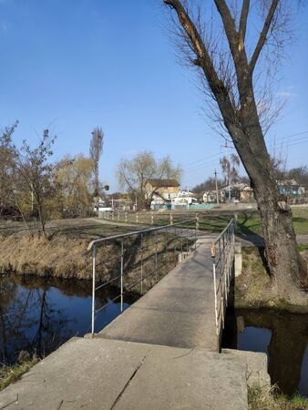 a small footbridge across the riverの写真素材