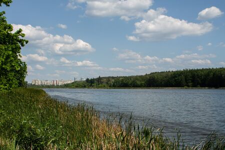 large lake in the forest against of the cityの写真素材