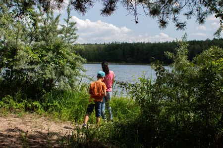 woman with a child near lake in the forestの写真素材