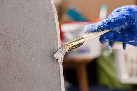 painter paints a tree with a brush with gloveの写真素材