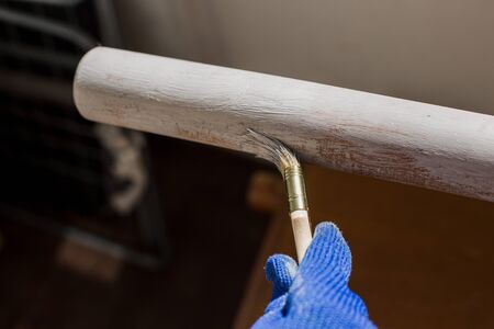 painter paints a tree with a brush with gloveの写真素材